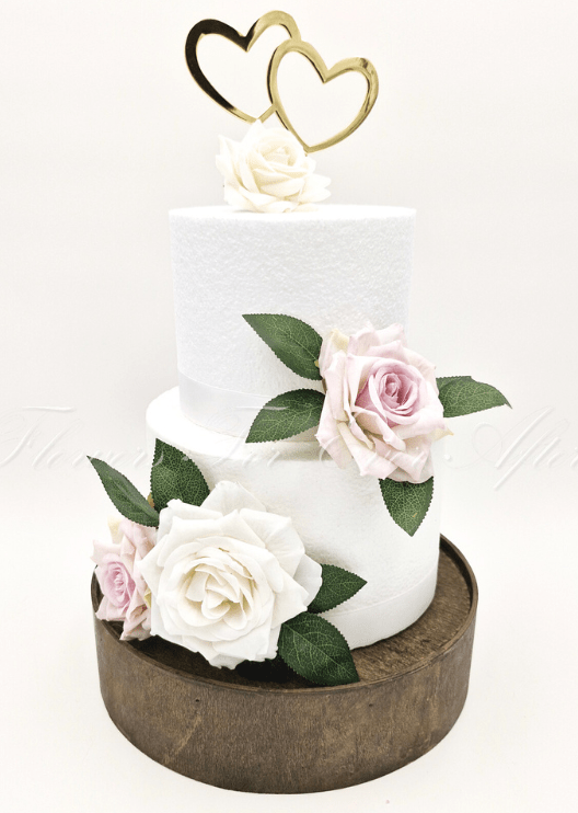 Artificial wedding cake decoration with ivory and pale lavender faux roses, green leaves and a gold double-heart topper. For birthday, event and celebration cakes. Made in Melbourne by Flowers For Ever After, shipping Australia and Worldwide.