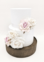 Artificial wedding cake decoration with ivory and pale lavender faux roses arranged in clusters over two tiers. For birthday, event and celebration cakes. Made in Melbourne by Flowers For Ever After, shipping Australia and Worldwide.
