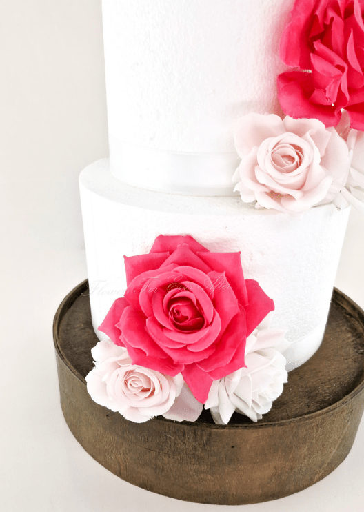 Artificial wedding cake flower decoration, angled view of mixed faux blooms and foliage. For birthday, event and celebration cakes. Made in Melbourne by Flowers For Ever After, shipping Australia and Worldwide.