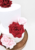 Artificial wedding cake decoration with mixed faux blooms and green foliage arranged over two tiers. For birthday, event and celebration cakes. Made in Melbourne by Flowers For Ever After, shipping Australia and Worldwide.