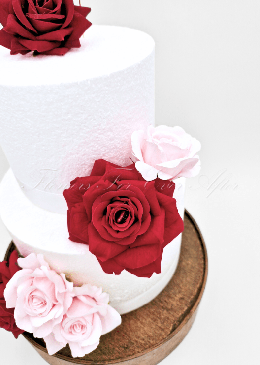 Artificial wedding cake decoration with mixed faux blooms and green foliage arranged over two tiers. For birthday, event and celebration cakes. Made in Melbourne by Flowers For Ever After, shipping Australia and Worldwide.
