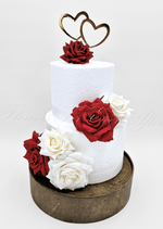 Artificial wedding cake decoration close-up showing faux flower petals and green foliage. For birthday, event and celebration cakes. Made in Melbourne by Flowers For Ever After, shipping Australia and Worldwide.