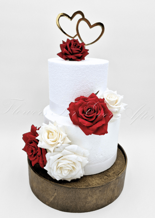 Artificial wedding cake decoration close-up showing faux flower petals and green foliage. For birthday, event and celebration cakes. Made in Melbourne by Flowers For Ever After, shipping Australia and Worldwide.