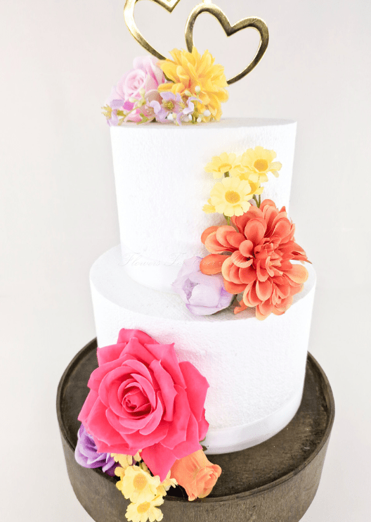 Artificial wedding cake flower close-up showing faux rose petals and green leaves. For birthday, event and celebration cakes. Made in Melbourne by Flowers For Ever After, shipping Australia and Worldwide.