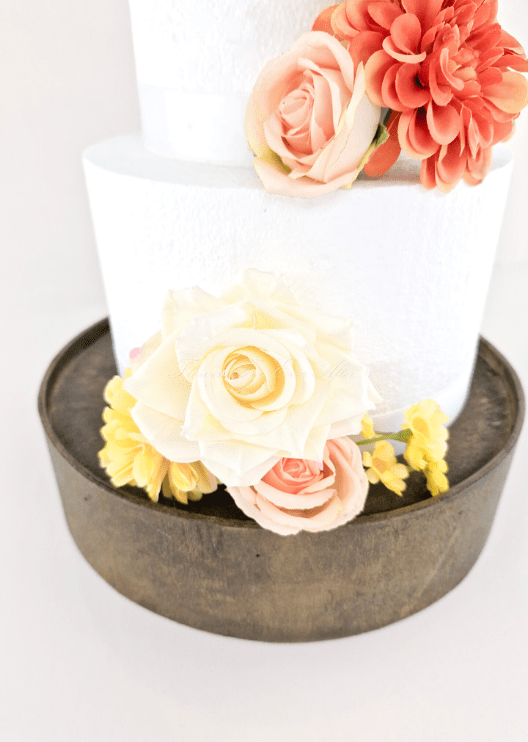 Artificial wedding cake decoration, angled view of faux roses placed at the upper and lower tiers. For birthday, event and celebration cakes. Made in Melbourne by Flowers For Ever After, shipping Australia and Worldwide.