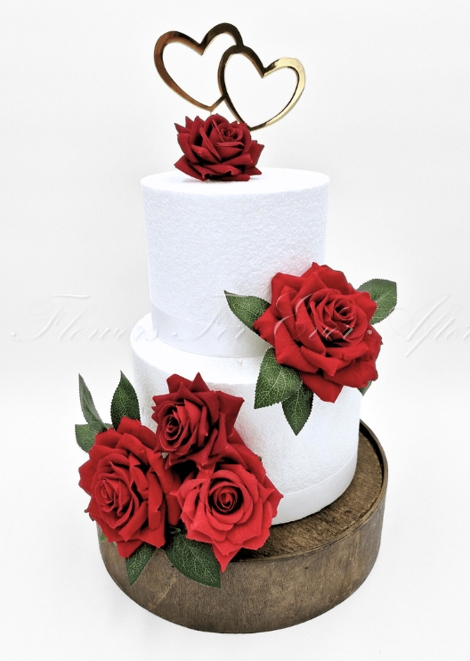 Artificial wedding cake decoration with faux flowers and green foliage arranged in floral clusters over the cake tiers. For birthday, event and celebration cakes. Made in Melbourne by Flowers For Ever After, shipping Australia and Worldwide.