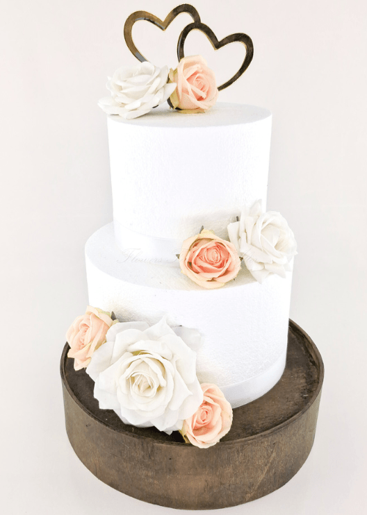 Artificial wedding cake flower decoration, angled view of faux rose clusters across the tiers. For birthday, event and celebration cakes. Made in Melbourne by Flowers For Ever After, shipping Australia and Worldwide.
