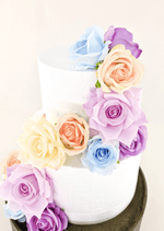 Artificial wedding cake flower decoration with faux rose clusters arranged at the tier edges. For birthday, event and celebration cakes. Made in Melbourne by Flowers For Ever After, shipping Australia and Worldwide.