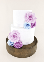 Artificial wedding cake floral decoration, angled view of faux rose clusters across the tiers. For birthday, event and celebration cakes. Made in Melbourne by Flowers For Ever After, shipping Australia and Worldwide.