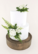 Artificial wedding cake decoration with white faux roses, white orchids and green foliage placed on top and at the lower tier. For birthday, event and celebration cakes. Made in Melbourne by Flowers For Ever After, shipping Australia and Worldwide.