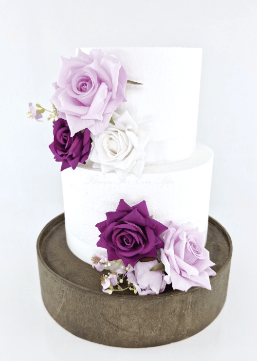 Artificial wedding cake floral decoration with faux rose clusters arranged across the tiers. For birthday, event and celebration cakes. Made in Melbourne by Flowers For Ever After, shipping Australia and Worldwide.