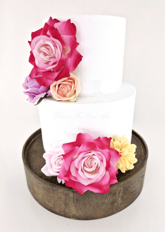 Artificial wedding cake decoration, angled view of faux roses arranged across two tiers. For birthday, event and celebration cakes. Made in Melbourne by Flowers For Ever After, shipping Australia and Worldwide.