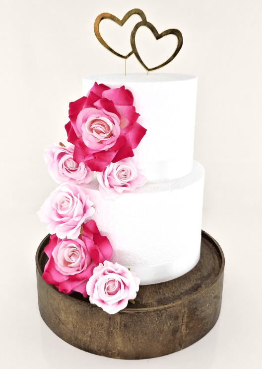 Artificial wedding cake decoration, angled view of blue and white faux roses across the tiers. For birthday, event and celebration cakes. Made in Melbourne by Flowers For Ever After, shipping Australia and Worldwide.
