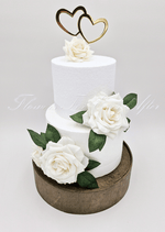 Artificial wedding cake decoration close-up with ivory faux roses and green foliage. For birthday, event and celebration cakes. Made in Melbourne by Flowers For Ever After, shipping Australia and Worldwide.