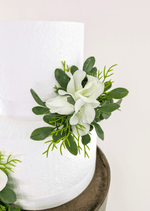 Artificial wedding cake flower detail showing white faux orchids, rosebuds and rounded green leaves. For birthday, event and celebration cakes. Made in Melbourne by Flowers For Ever After, shipping Australia and Worldwide.