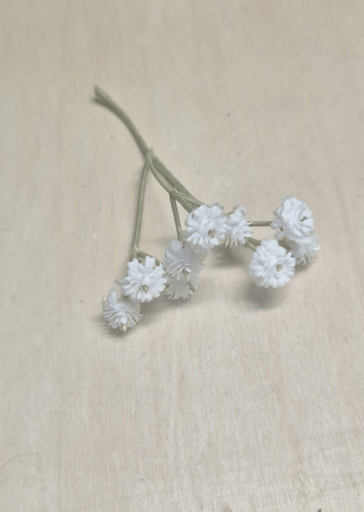 Artificial wedding flower detail showing a branching sprig of tiny white faux baby's breath blooms. Made in Melbourne by Flowers For Ever After, shipping Australia and Worldwide.