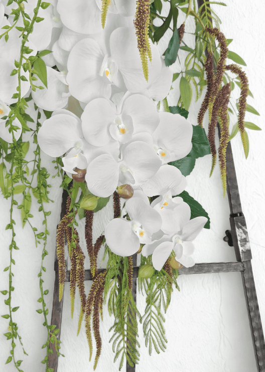 Artificial wedding arbor arrangement detail showing cascading white faux orchids, bronze textured strands and trailing green foliage. Made in Melbourne by Flowers For Ever After, shipping Australia and Worldwide.