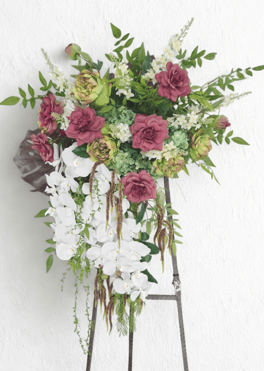 Artificial wedding hanging arbor arrangement with mauve and green faux roses, pale green hydrangea, white orchids, white flower spikes and long bronze and green strands. Made in Melbourne by Flowers For Ever After, shipping Australia and Worldwide.