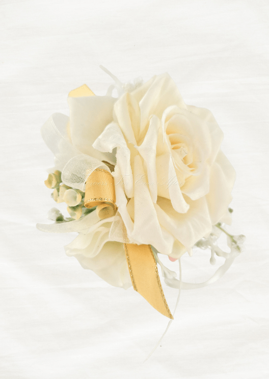 Artificial wedding wrist corsage, side view of layered ivory faux rose petals, pale sprigs and gold-edged yellow ribbons. For formals, proms and ball occasions. Made in Melbourne by Flowers For Ever After, shipping Australia and Worldwide.