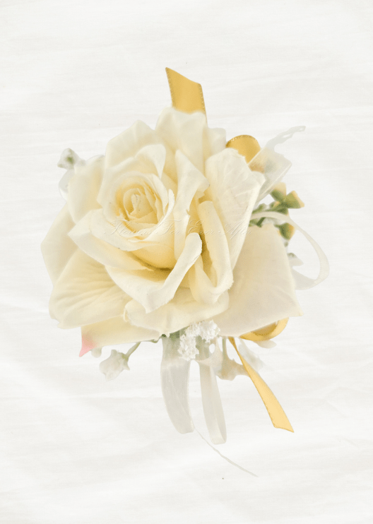 Artificial wedding wrist corsage, front view of an ivory faux rose with white ribbons and gold-edged yellow ribbon loops. For formals, proms and ball occasions. Made in Melbourne by Flowers For Ever After, shipping Australia and Worldwide.