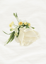Artificial wedding boutonniere, top view of an ivory faux rose, yellow-tipped sprigs, tiny white flowers and green leaves. For formals, proms and ball occasions. Made in Melbourne by Flowers For Ever After, shipping Australia and Worldwide.