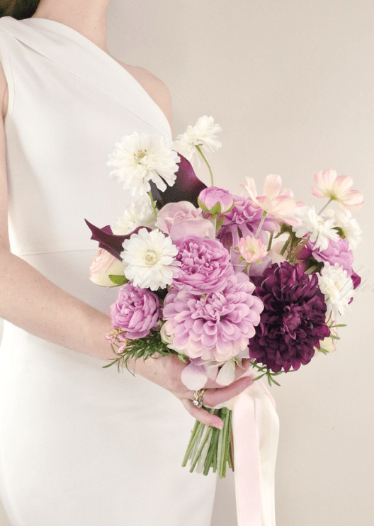 Artificial wedding bridal bouquet, angled view of lilac, burgundy and white faux flowers and green leaves. Made in Melbourne by Flowers For Ever After, shipping Australia and Worldwide.