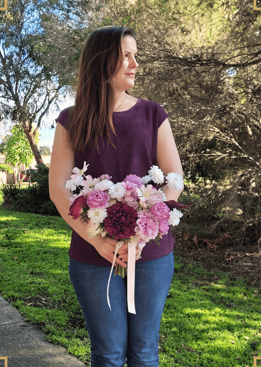 Artificial wedding bridal bouquet, handheld angled view of lilac, burgundy and white faux flowers and green leaves. Made in Melbourne by Flowers For Ever After, shipping Australia and Worldwide.