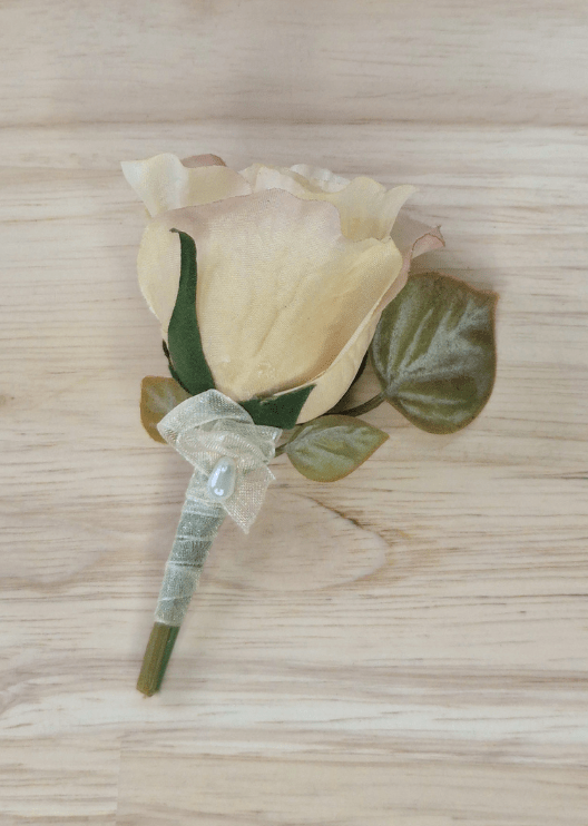 Artificial wedding boutonniere with a champagne faux rose, muted green leaves and sheer ivory ribbon-wrapped stems. For formals, proms and ball occasions. Made in Melbourne by Flowers For Ever After, shipping Australia and Worldwide.