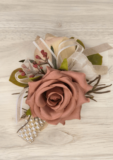Artificial wedding wrist corsage with dusty rose and champagne faux roses, pink berry sprigs, ivory ribbon and pearl-style bracelet. For formals, proms and ball occasions. Made in Melbourne by Flowers For Ever After, shipping Australia and Worldwide.