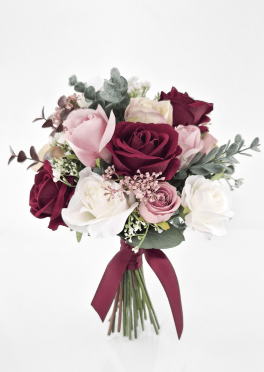 Artificial wedding bridesmaid bouquet, angled view of burgundy, blush and white faux roses, bronze flower clusters and burgundy ribbon bow. Made in Melbourne by Flowers For Ever After, shipping Australia and Worldwide.