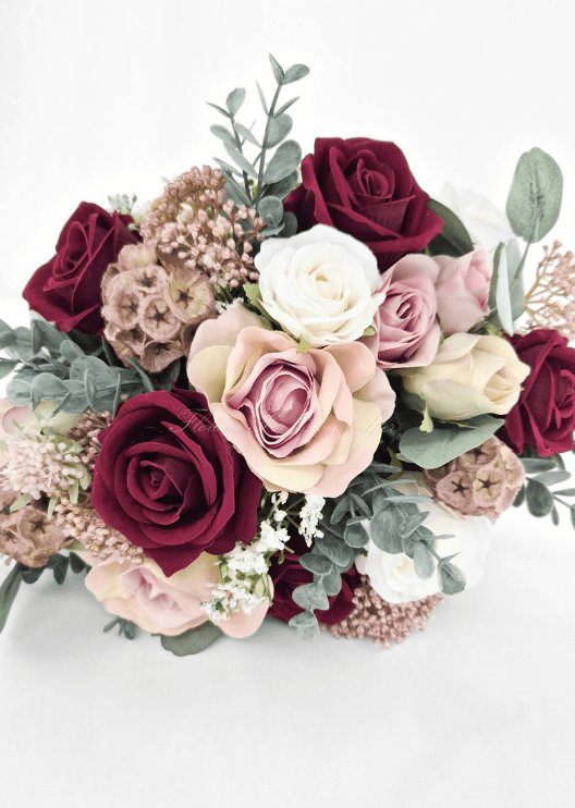 Artificial wedding bouquet, overhead view of burgundy, blush and white faux roses, tan seedpods and bronze clusters. Made in Melbourne by Flowers For Ever After, shipping Australia and Worldwide.