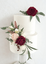Artificial wedding cake decoration with burgundy, blush and white faux roses, bronze sprigs and eucalyptus in upper and lower clusters. For birthday, event and celebration cakes. Made in Melbourne by Flowers For Ever After, shipping Australia and Worldwide.