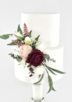 Artificial wedding cake decoration with burgundy, blush and white faux roses, bronze sprigs and long green leaves at the tier join. For birthday, event and celebration cakes. Made in Melbourne by Flowers For Ever After, shipping Australia and Worldwide.
