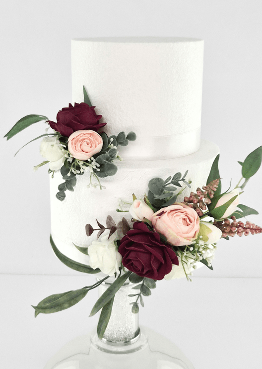 Artificial wedding cake decoration with two clusters of burgundy, blush and white faux roses, bronze sprigs and eucalyptus. For birthday, event and celebration cakes. Made in Melbourne by Flowers For Ever After, shipping Australia and Worldwide.