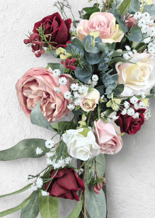 Artificial wedding arbor flower detail showing blush and burgundy faux roses, cream blooms, tiny white flowers and eucalyptus. Made in Melbourne by Flowers For Ever After, shipping Australia and Worldwide.