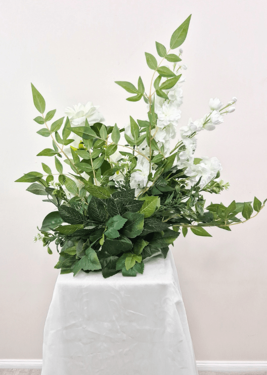 Artificial wedding pedestal arrangement, reverse view of white faux flower spikes, layered blooms and green foliage. Made in Melbourne by Flowers For Ever After, shipping Australia and Worldwide.