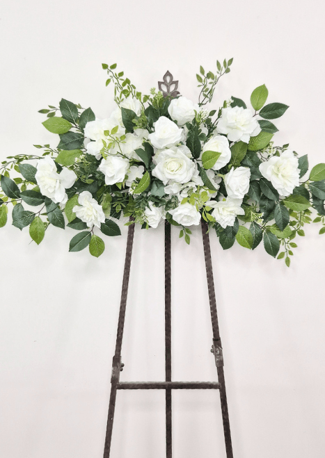 Artificial wedding large horizontal ceremony spray with white faux roses, clustered blooms, small buds and green foliage. Made in Melbourne by Flowers For Ever After, shipping Australia and Worldwide.