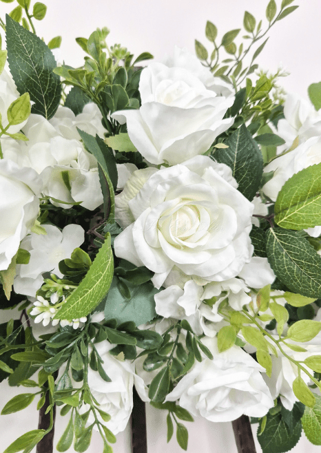 Artificial wedding ceremony flower close-up with white faux roses, clustered blooms and veined green leaves. Made in Melbourne by Flowers For Ever After, shipping Australia and Worldwide.