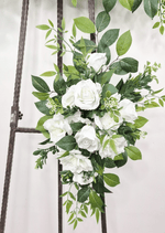 Artificial wedding tieback close-up with white faux roses, layered blooms, small buds and broad green leaves. Made in Melbourne by Flowers For Ever After, shipping Australia and Worldwide.