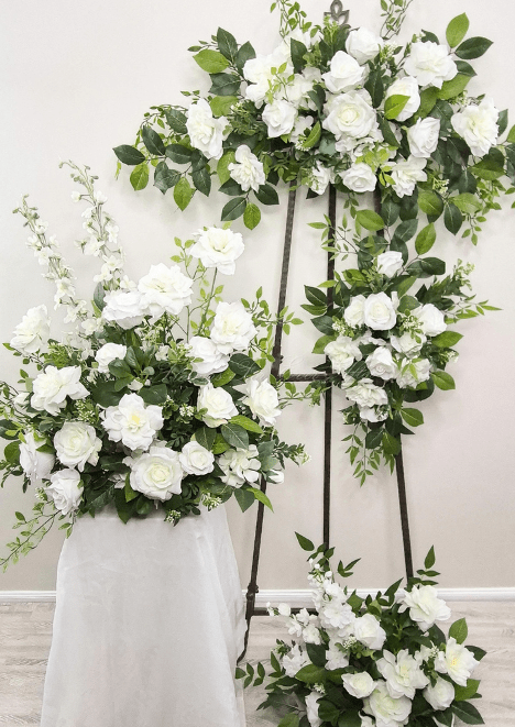 Artificial wedding ceremony set with white faux roses and green foliage in large sprays, a tieback and floor arrangement. Made in Melbourne by Flowers For Ever After, shipping Australia and Worldwide.