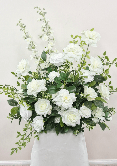 Artificial wedding large pedestal arrangement with white faux roses, layered blooms, tall white flower spikes and green foliage. Made in Melbourne by Flowers For Ever After, shipping Australia and Worldwide.