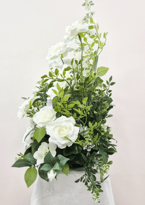 Artificial wedding pedestal arrangement, side view of white faux roses, tall flower spikes and dense green foliage. Made in Melbourne by Flowers For Ever After, shipping Australia and Worldwide.