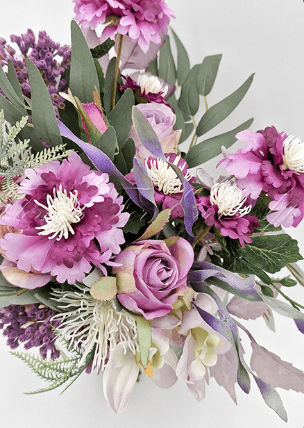 Artificial wedding bridesmaid bouquet, angled view of purple faux flowers, mauve roses, white spiky blooms and eucalyptus. Made in Melbourne by Flowers For Ever After, shipping Australia and Worldwide.