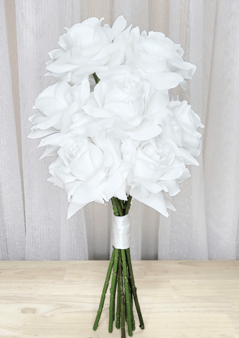 Artificial wedding bridesmaid bouquet with white faux roses and gathered green stems wrapped in white ribbon. Made in Melbourne by Flowers For Ever After, shipping Australia and Worldwide.