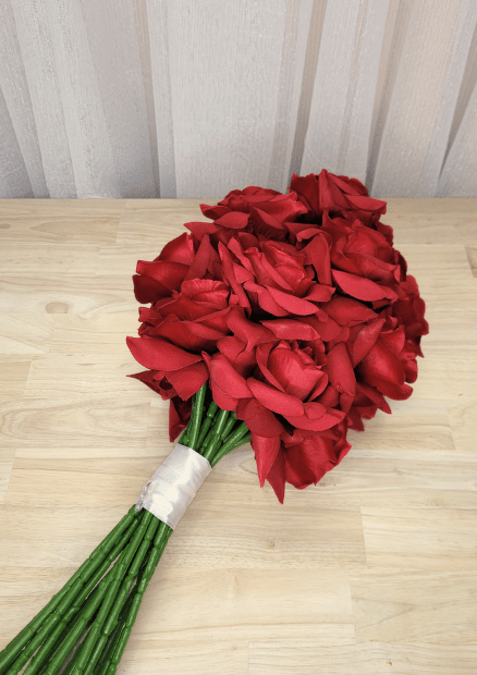 Artificial wedding bouquet, reverse view of red faux roses, gathered green stems and white ribbon wrapping. Made in Melbourne by Flowers For Ever After, shipping Australia and Worldwide.