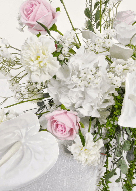 Artificial wedding table garland, angled view of pale pink and white faux roses and trailing green foliage. Made in Melbourne by Flowers For Ever After, shipping Australia and Worldwide.