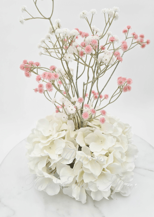 Artificial wedding centrepiece close-up with white faux hydrangea clusters and branching pink and white baby's breath. Made in Melbourne by Flowers For Ever After, shipping Australia and Worldwide.