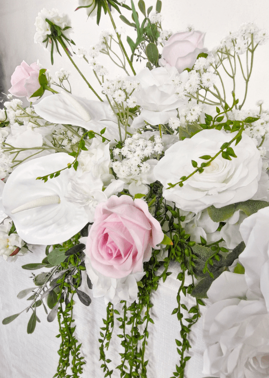 Artificial wedding table garland close-up showing pale pink and white faux roses, white blooms and green leaves. Made in Melbourne by Flowers For Ever After, shipping Australia and Worldwide.