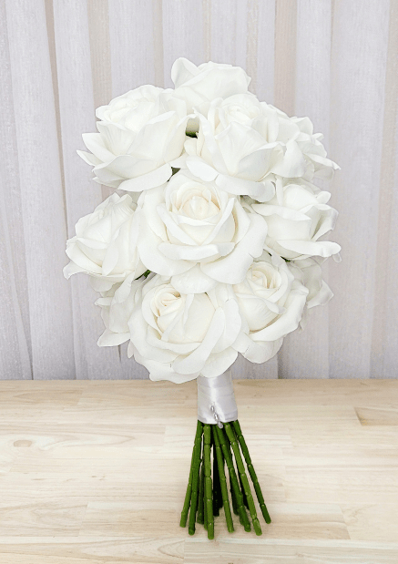Artificial wedding bouquet, angled view of white-ivory faux roses and gathered green stems. Made in Melbourne by Flowers For Ever After, shipping Australia and Worldwide.