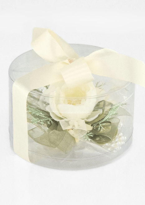 Artificial wedding corsage gift presentation with ivory faux blooms and fine sprigs in a clear rounded box tied with ivory ribbon. For formals, proms and ball occasions. Made in Melbourne by Flowers For Ever After, shipping Australia and Worldwide.